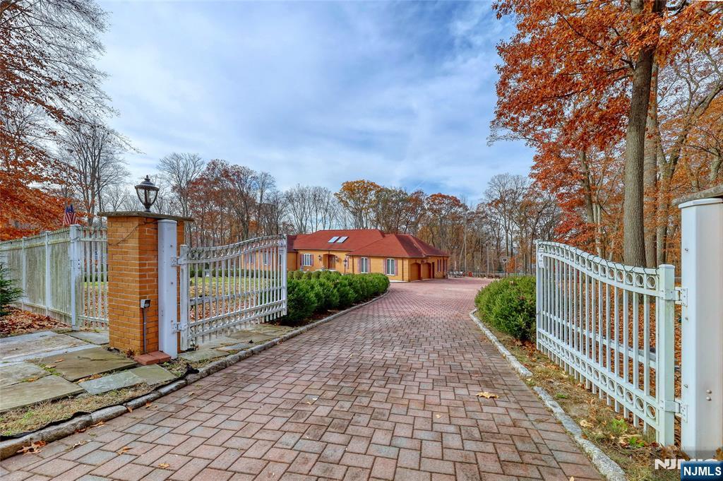 91 Chestnut Ridge Road Saddle River, NJ 07458 - Photo 42 of 50 a view of a pathway with a wrought fence