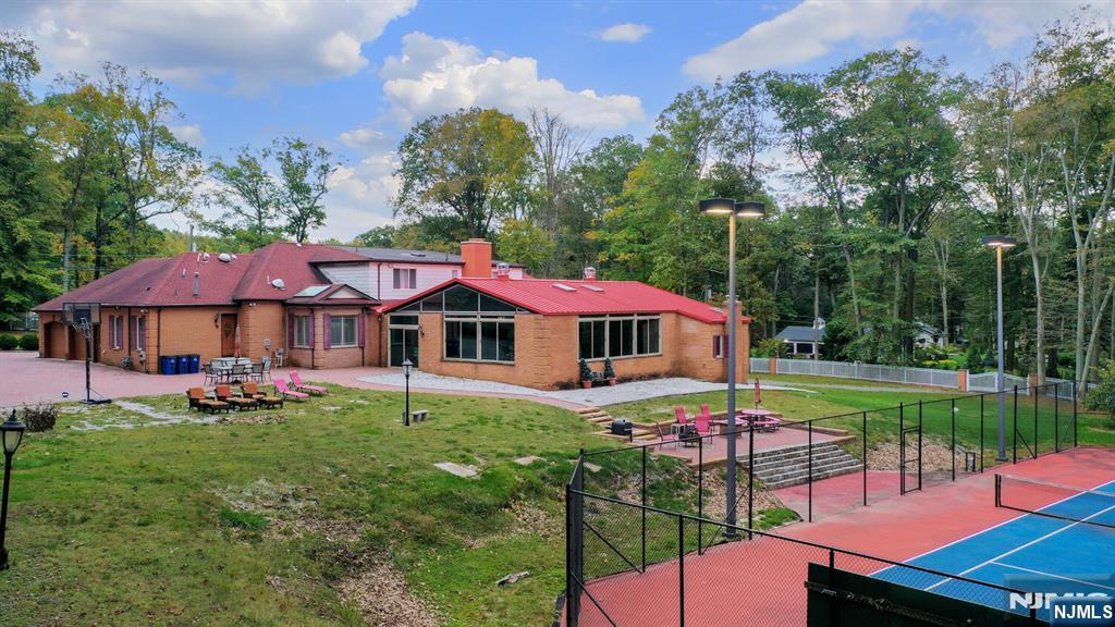 91 Chestnut Ridge Road Saddle River, NJ 07458 - Photo 44 of 50 a view of a sitting area with swimming pool and furniture