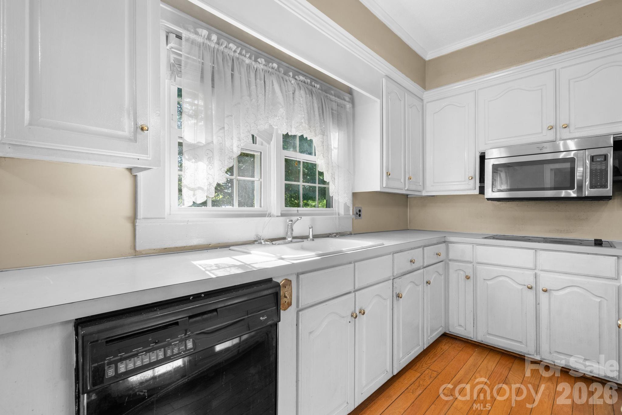 144 Hunter Bridge Road Stony Point, NC 28678 - Photo 9 of 45 a kitchen with a sink stove and microwave