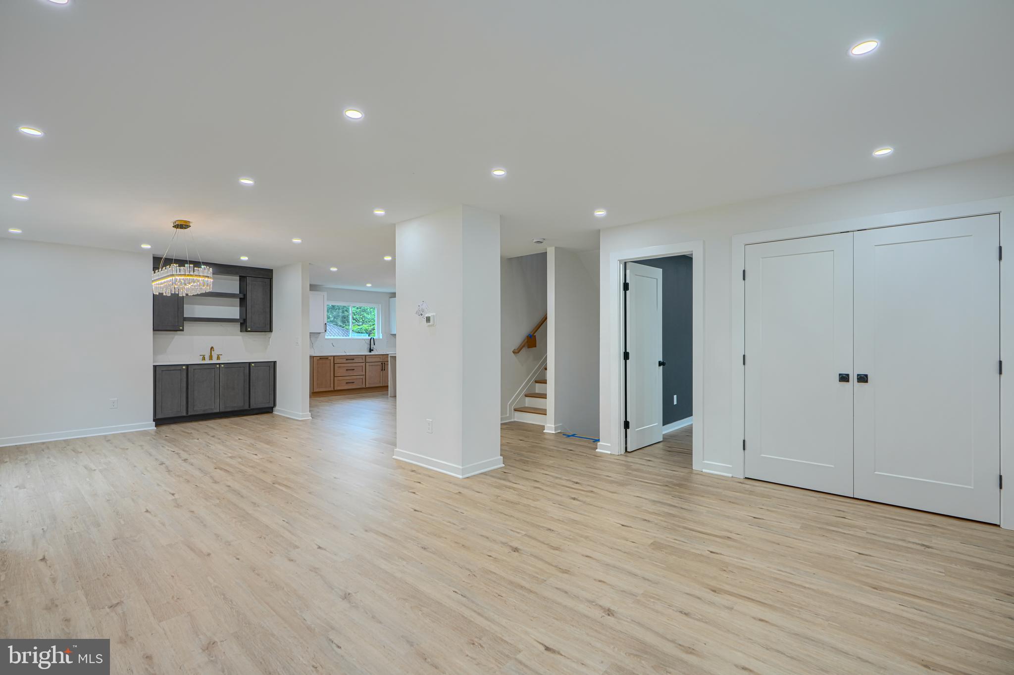 3410 Pinkney Road Baltimore, MD 21215 - Photo 10 of 55 a view of a big room with wooden floor and a kitchen
