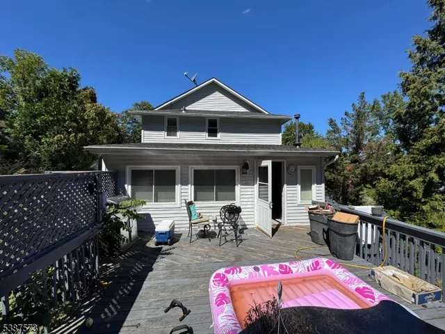 a view of house with swimming pool outdoor seating