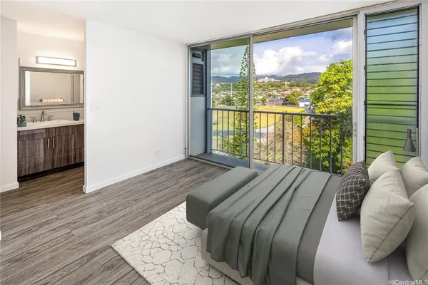 a bed sitting in a bedroom next to a large window