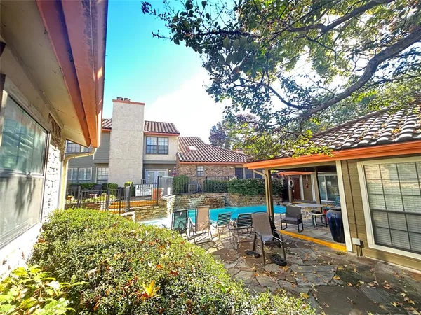 a view of a house with backyard porch and sitting area