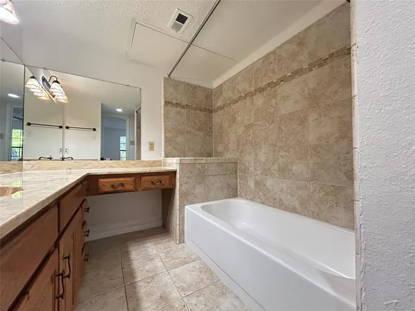 a bathroom with a bathtub and a sink