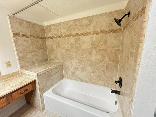 a bathroom with a bathtub and shower