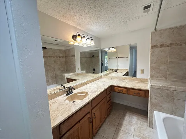 a bathroom with a sink double vanity and a mirror