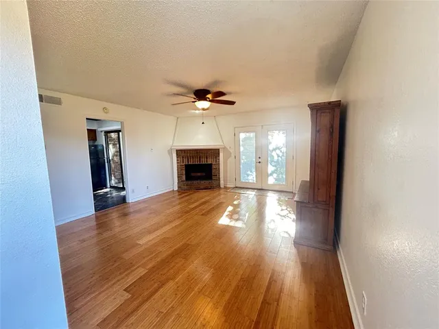 wooden floor in an empty room with a fireplace