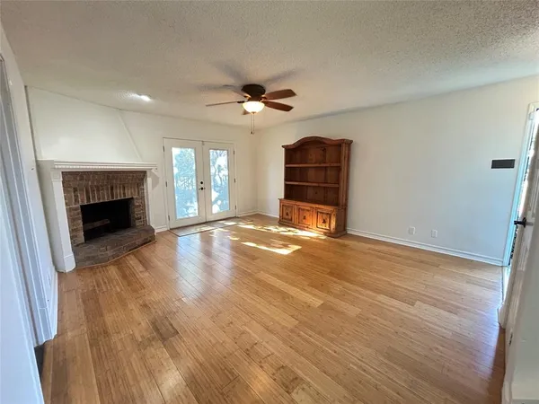 wooden floor fireplace and natural light in room