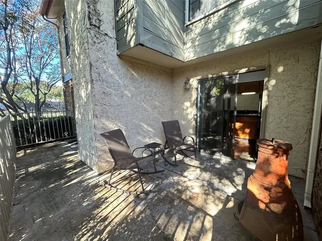 a view of a patio with table and chairs and potted plants