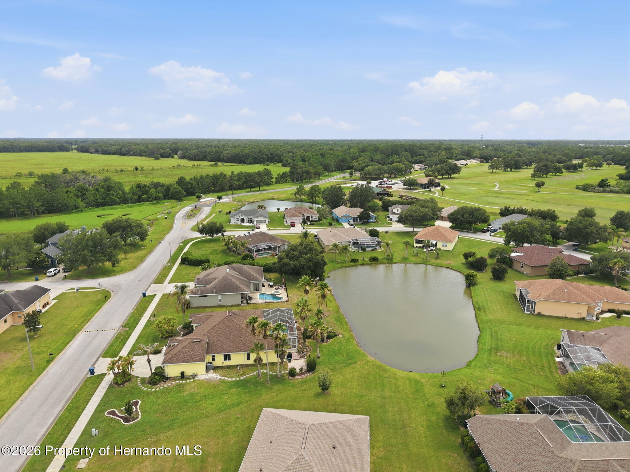 18131 Rivard Boulevard Brooksville, FL 34604 - Photo 59 of 66 an aerial view of residential houses with outdoor space and swimming pool