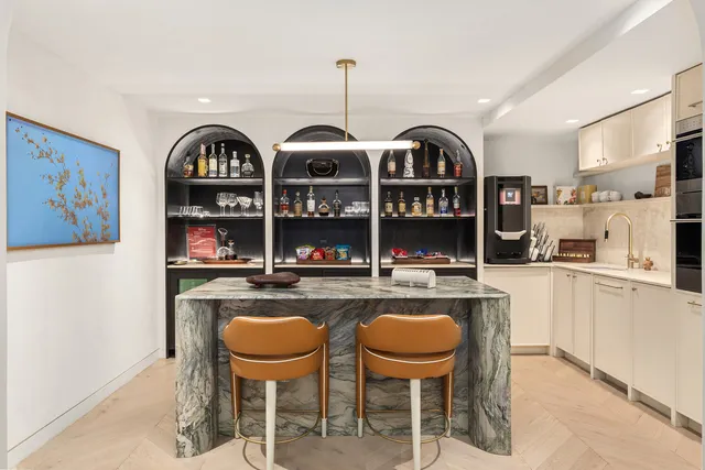 a kitchen with sink and chairs