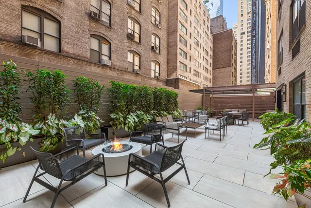 a view of a patio with couches and potted plants