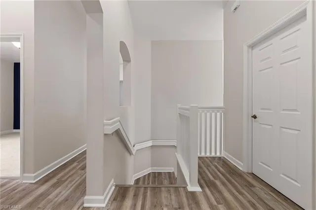 an empty room with windows and cabinet