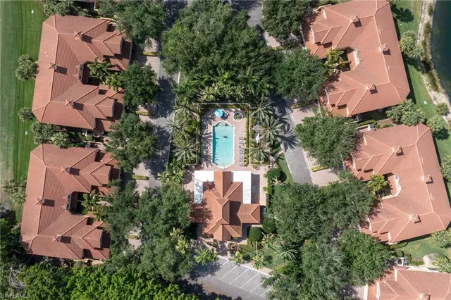 an aerial view of residential houses with outdoor space and lake view