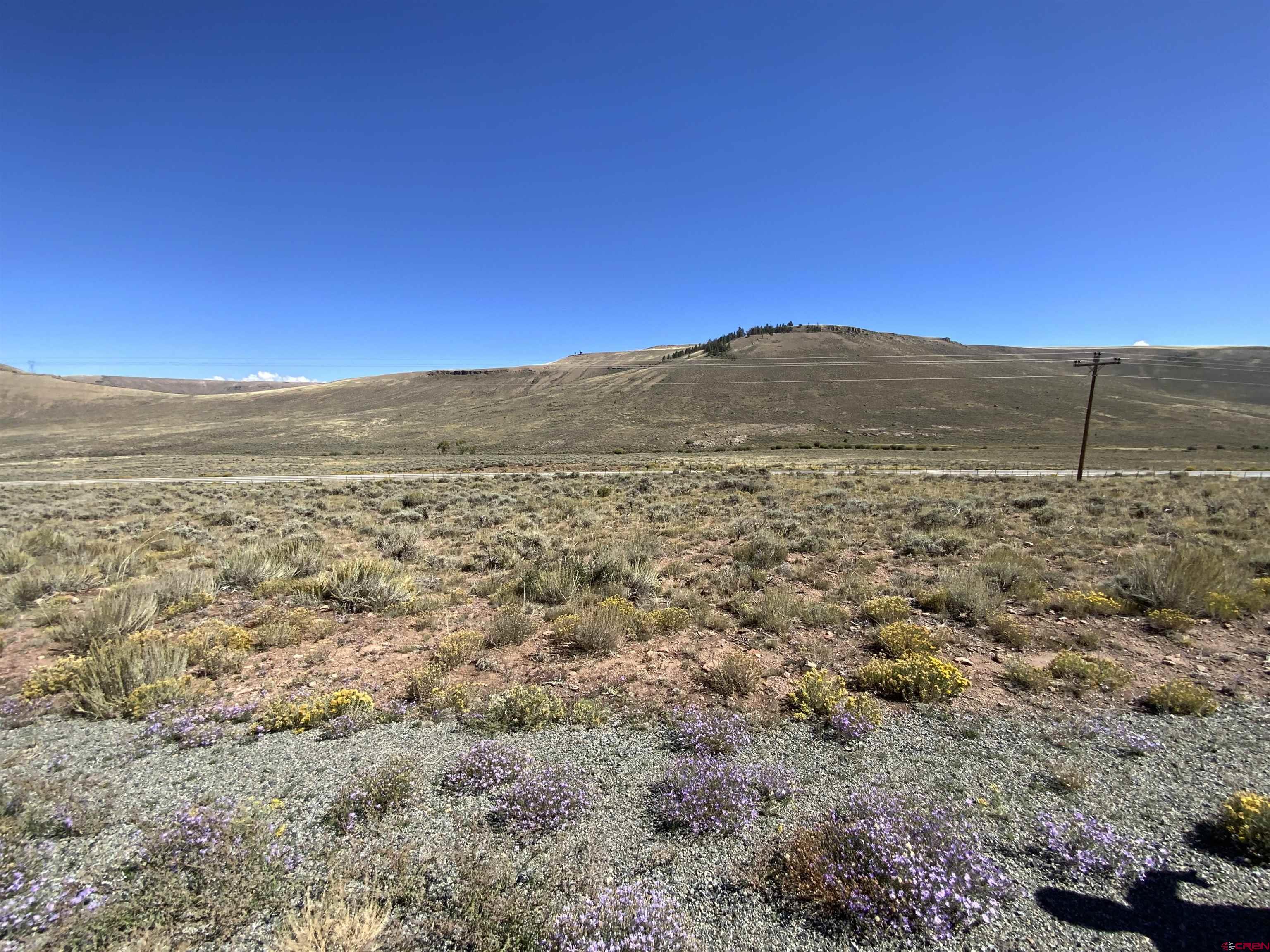 a view of a large mountain with mountains in the background