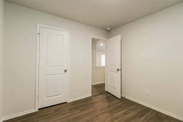 a view of an empty room and wooden floor