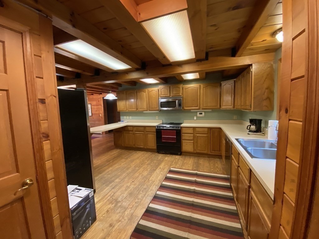2089 Greenwich Road Hardwick, MA 01082 - Photo 8 of 38 a large kitchen with stainless steel appliances granite countertop a sink and cabinets