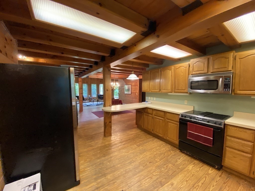 2089 Greenwich Road Hardwick, MA 01082 - Photo 9 of 38 a kitchen with stainless steel appliances granite countertop a stove a sink and a microwave