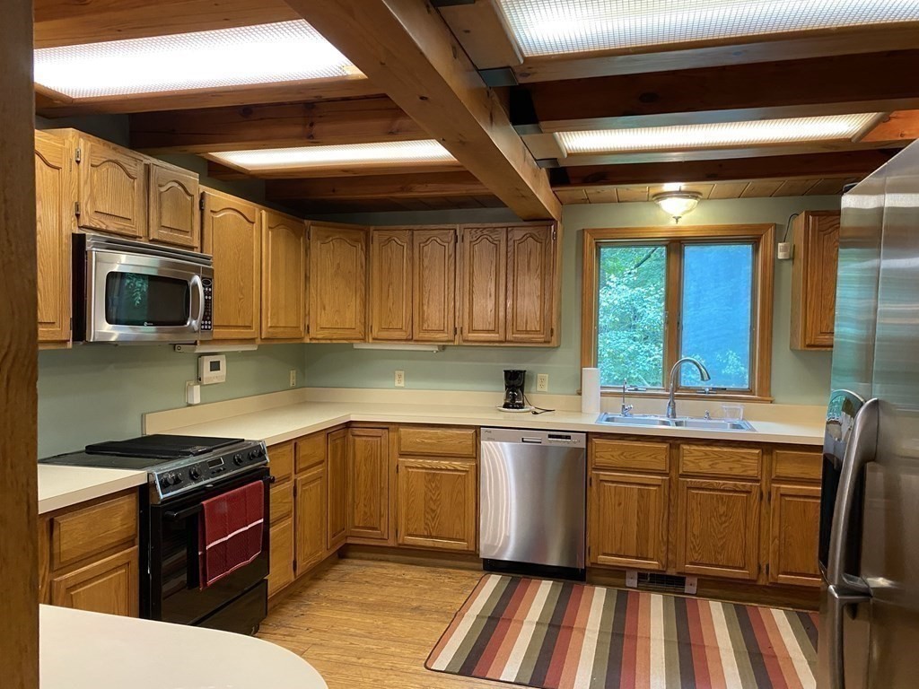 2089 Greenwich Road Hardwick, MA 01082 - Photo 10 of 38 a kitchen with a sink stove and microwave