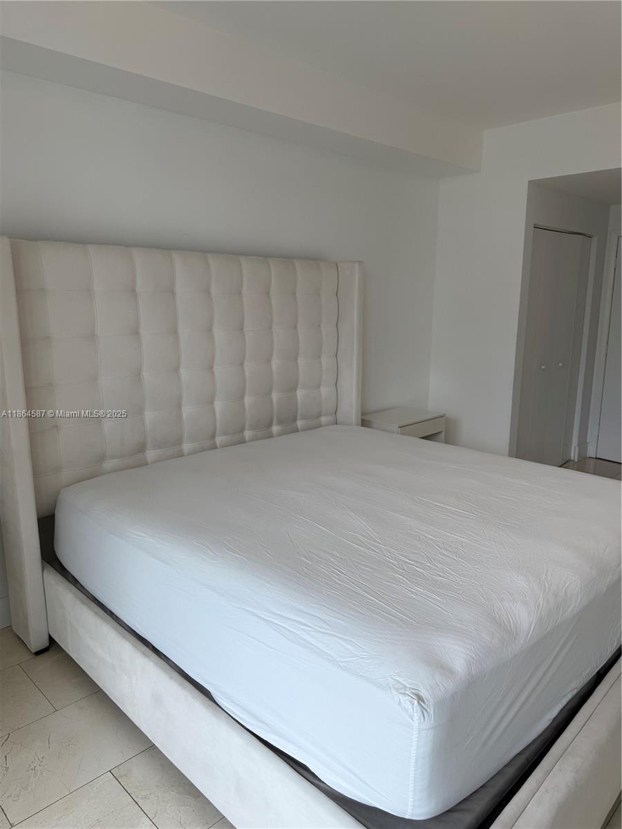 90 Southwest 3rd Street, Unit 2103 Miami, FL 33130 - Photo 13 of 31 a bedroom with a bed and a cabinet