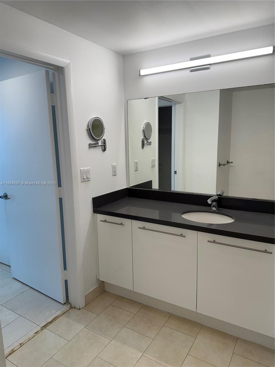 90 Southwest 3rd Street, Unit 2103 Miami, FL 33130 - Photo 18 of 31 a bathroom with a sink and a mirror