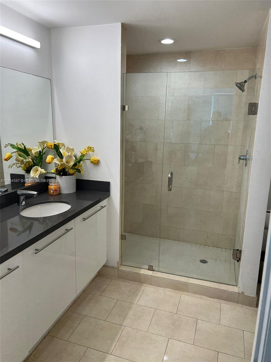 90 Southwest 3rd Street, Unit 2103 Miami, FL 33130 - Photo 19 of 31 a bathroom with a granite countertop sink a toilet and shower