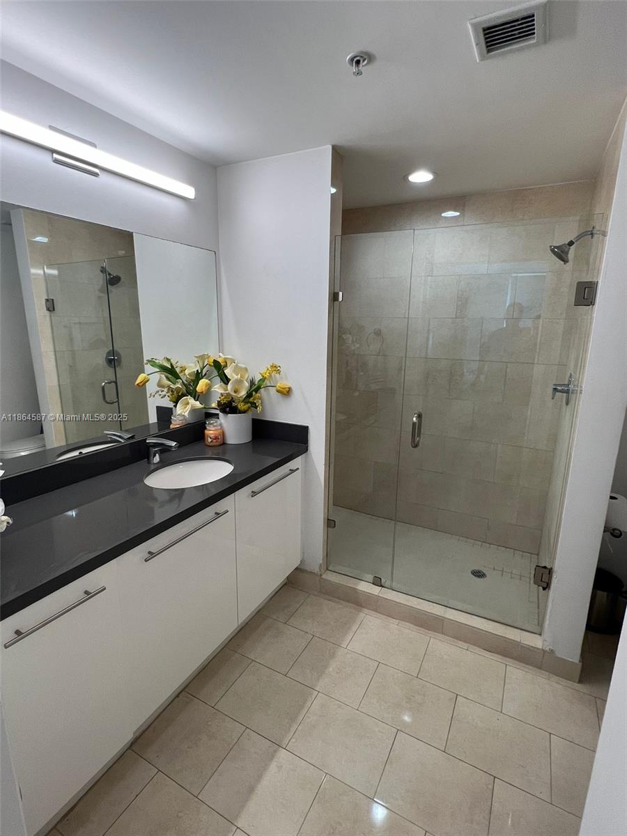 90 Southwest 3rd Street, Unit 2103 Miami, FL 33130 - Photo 20 of 31 a bathroom with a sink a toilet and shower