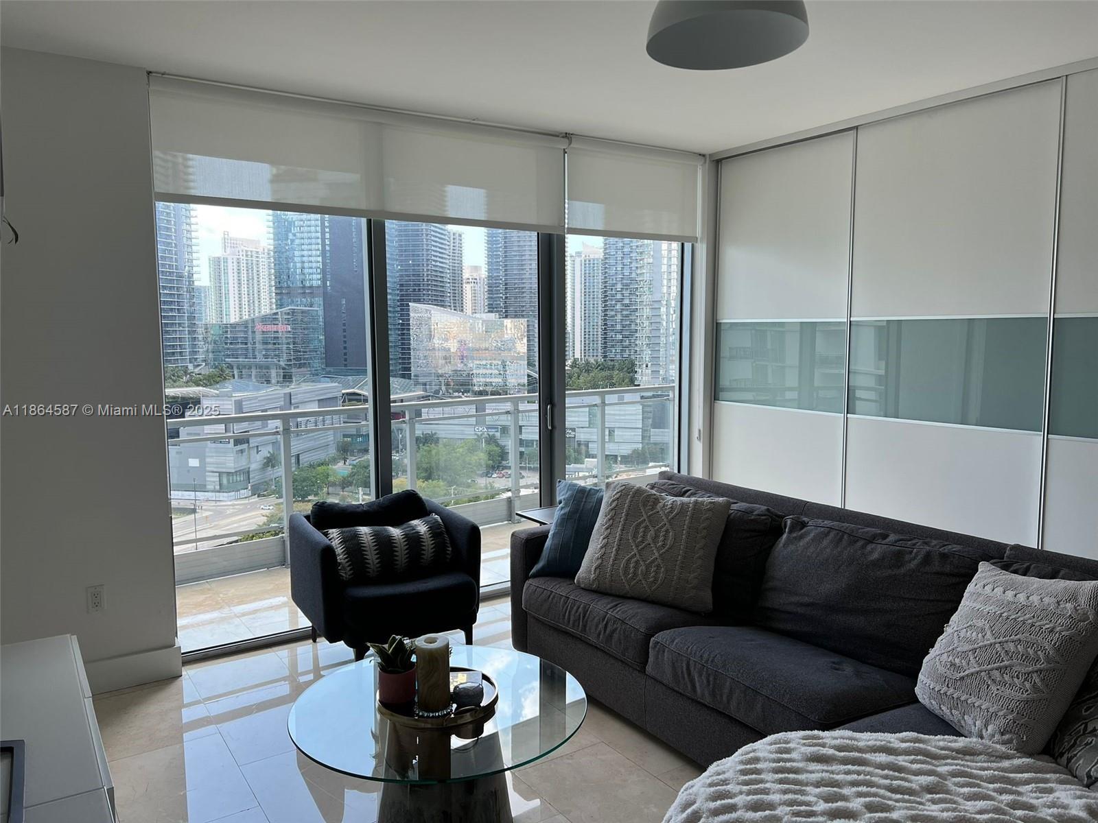 90 Southwest 3rd Street, Unit 2103 Miami, FL 33130 - Photo 3 of 31 a living room with furniture and a large window