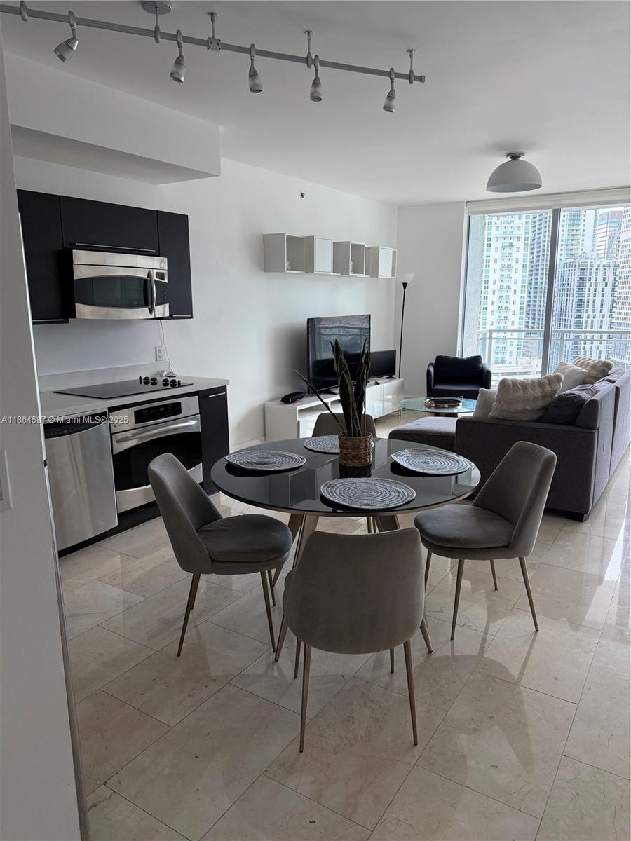 90 Southwest 3rd Street, Unit 2103 Miami, FL 33130 - Photo 4 of 31 a living room with furniture a fireplace and a flat screen tv