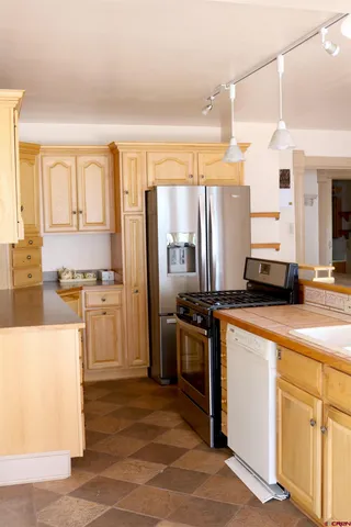 a kitchen with a refrigerator and a sink