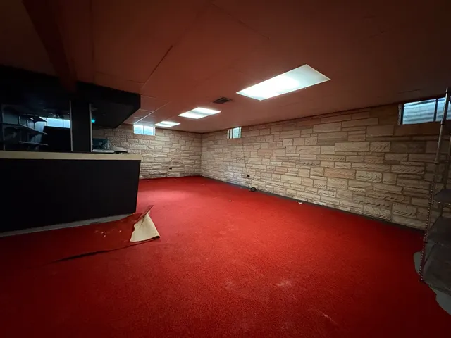 a view of outdoor space with pool table fireplace and window