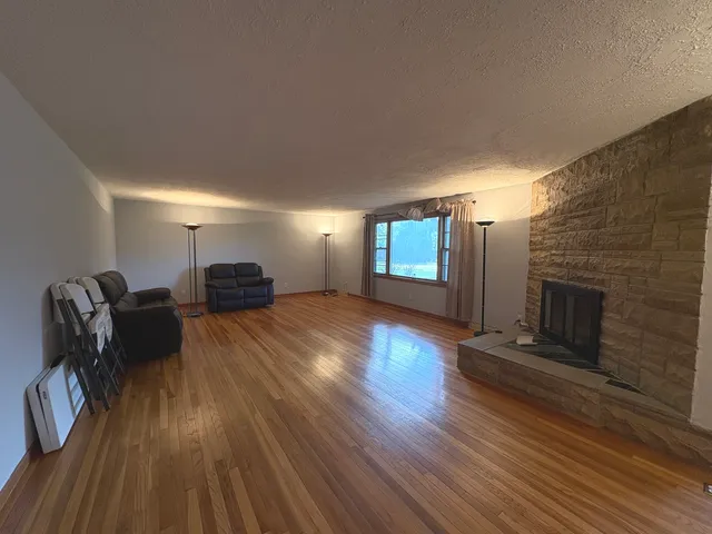 a view of a livingroom with furniture and a fireplace