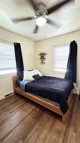 a living room with a bed furniture and a window