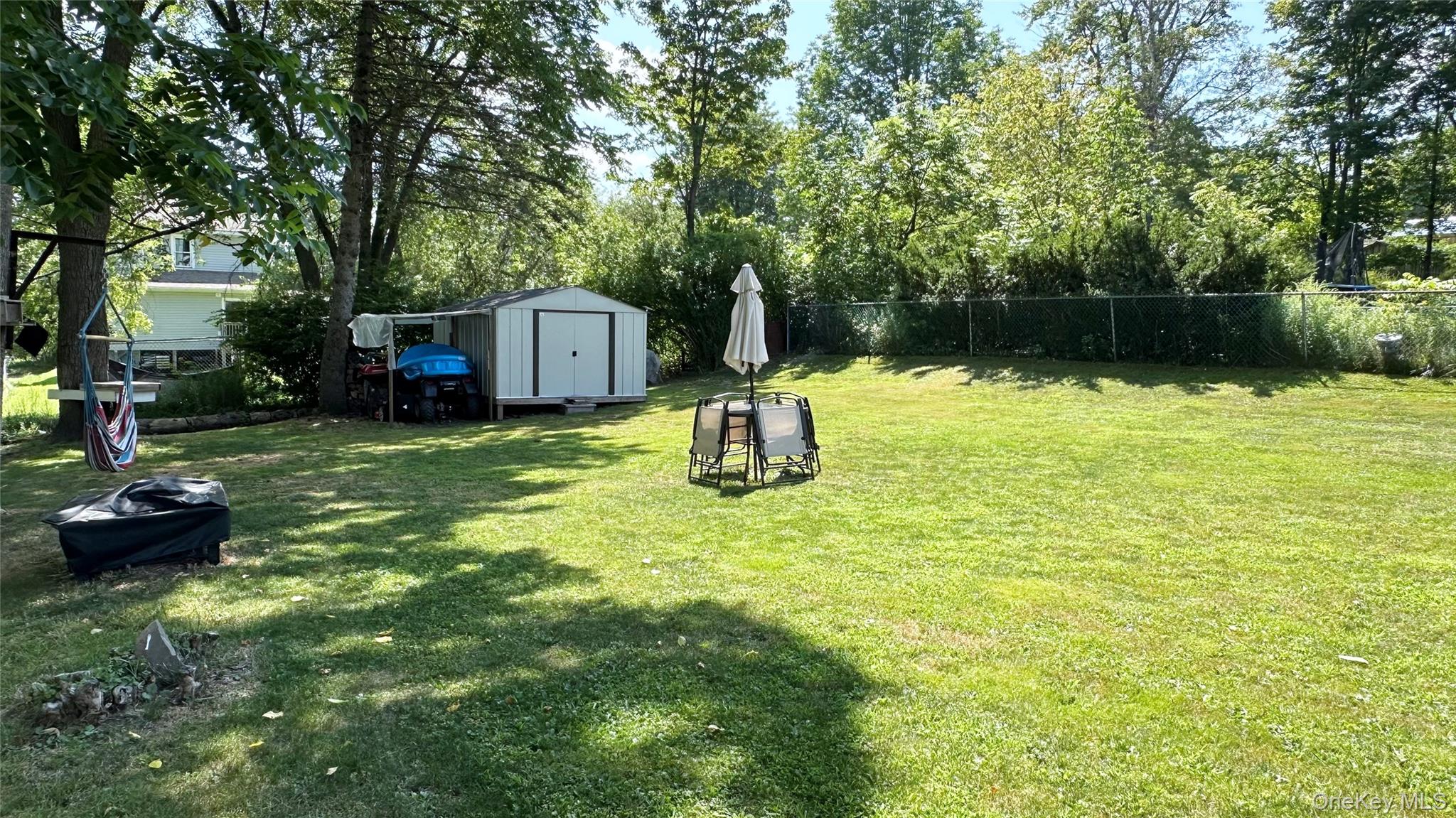 9 Hope Street Liberty, NY 12754 - Photo 23 of 24 a backyard of a house with yard and outdoor seating