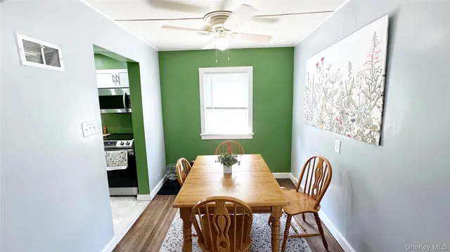 a view of a dining room with furniture and a window
