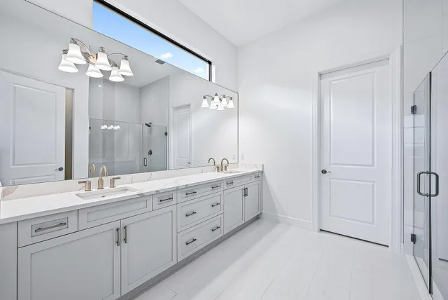 a bathroom with a double vanity sink mirror and double