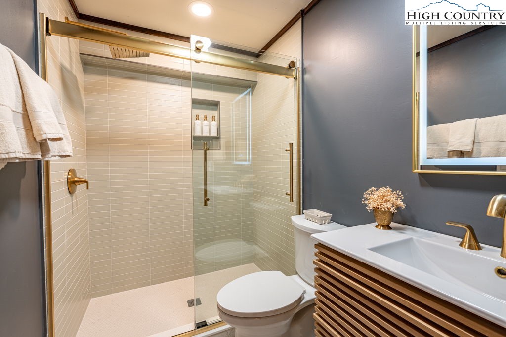 102 Ridge Drive Linville, NC 28646 - Photo 43 of 48 a bathroom with a sink a toilet and shower