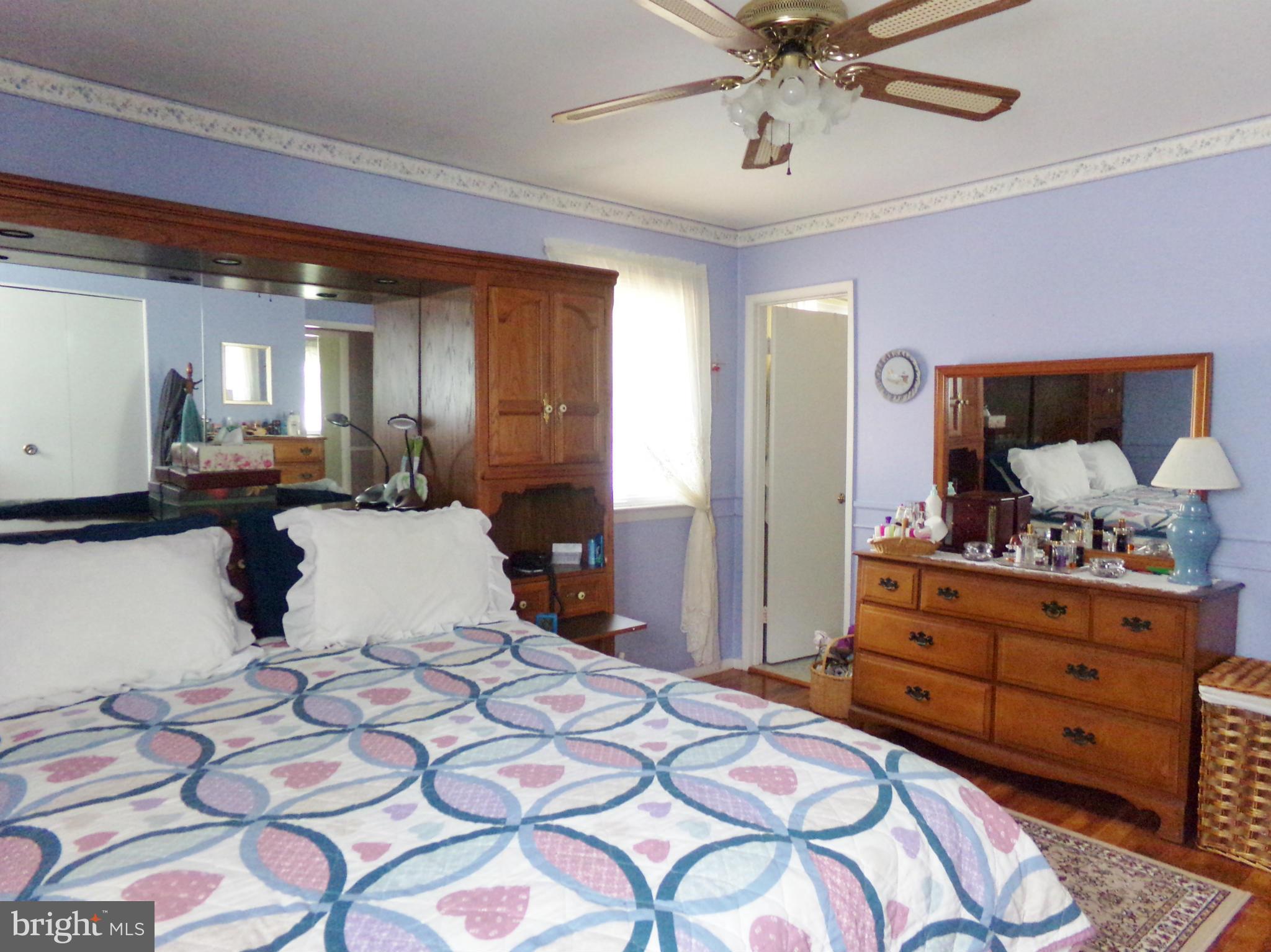 8113 Phirne Road East Glen Burnie, MD 21061 - Photo 11 of 27 a bedroom with a bed and ceiling fan