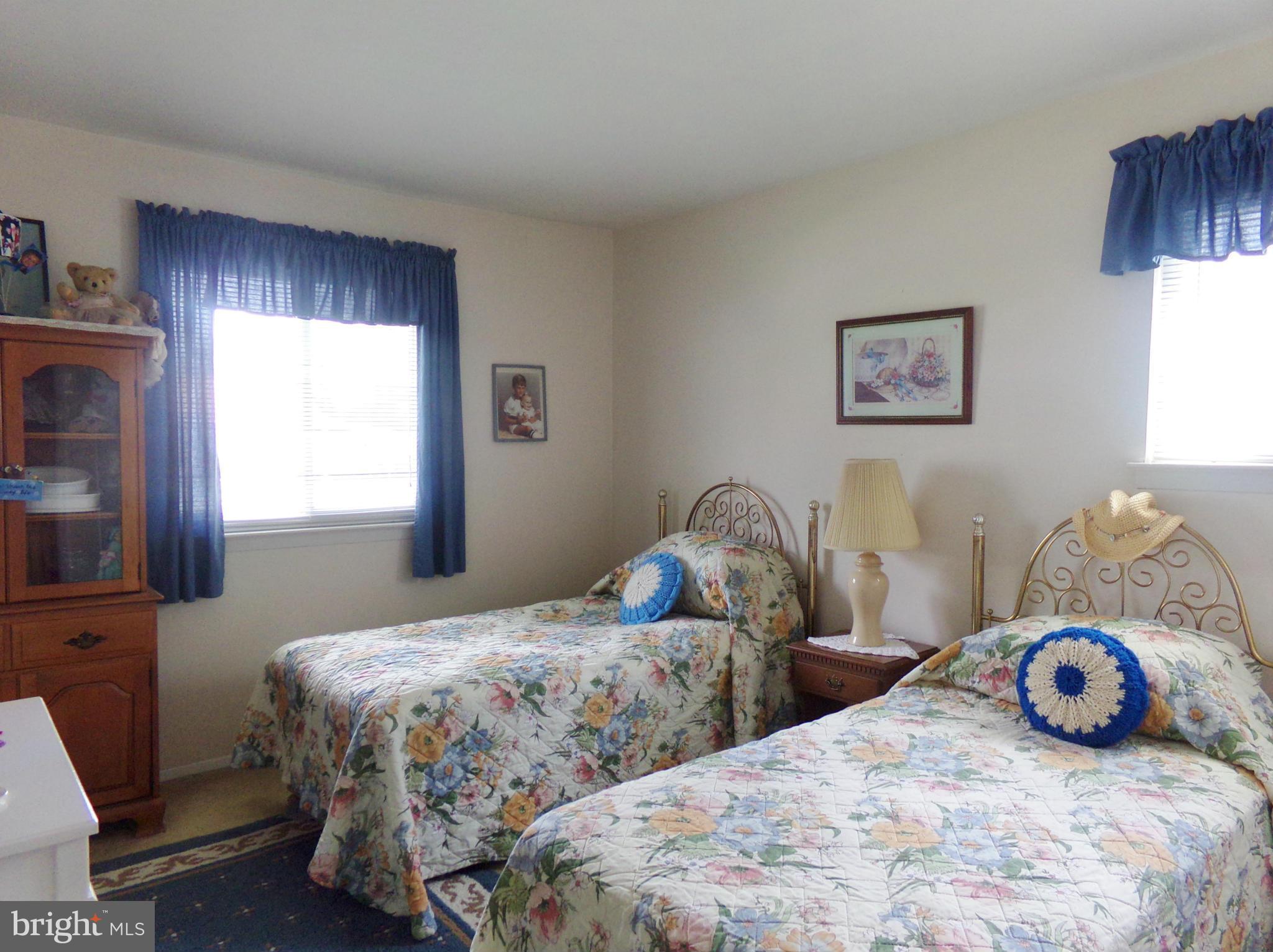 8113 Phirne Road East Glen Burnie, MD 21061 - Photo 12 of 27 a bedroom with two beds and a window