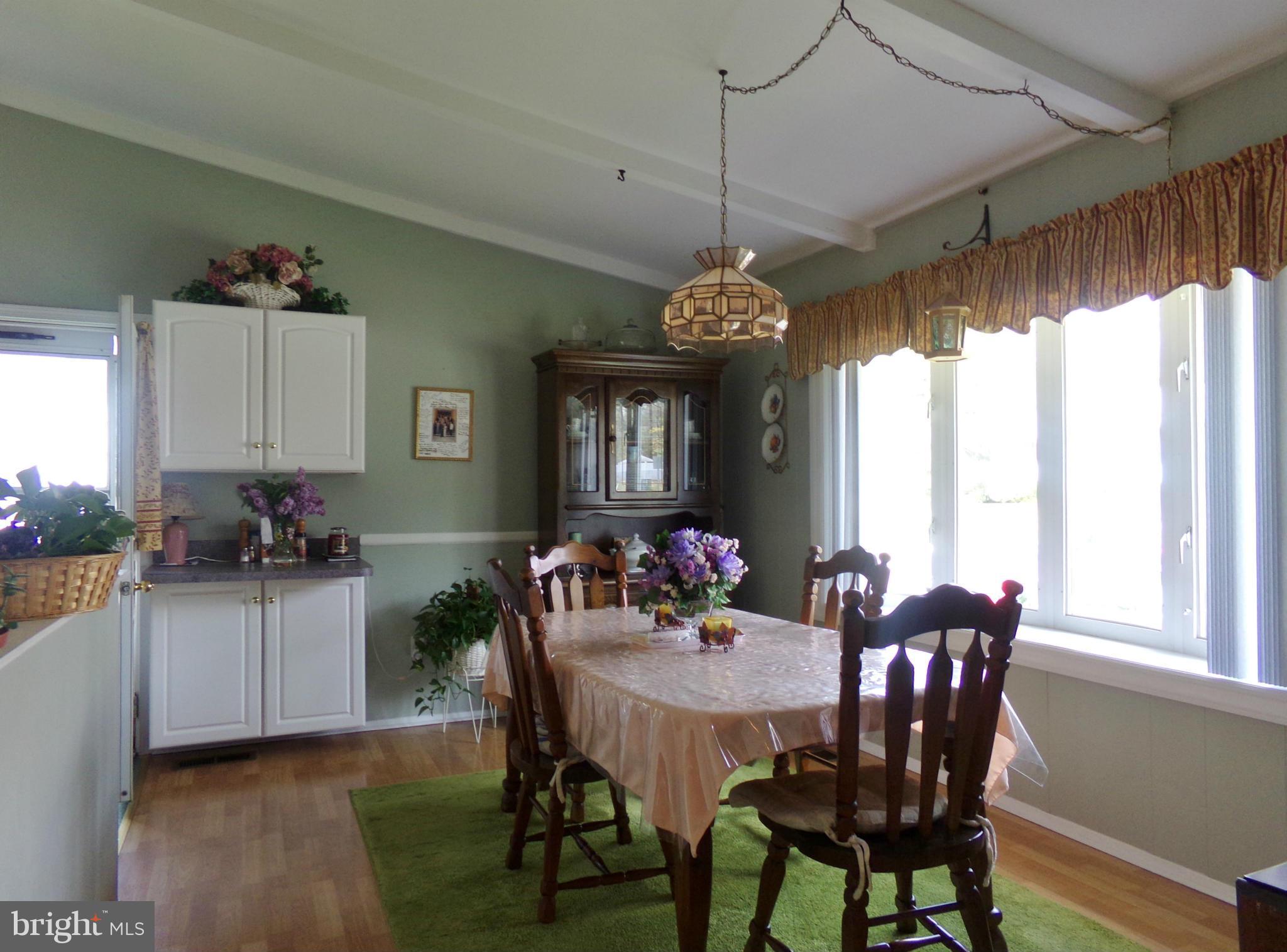 8113 Phirne Road East Glen Burnie, MD 21061 - Photo 3 of 27 a view of a dining room with furniture window and outside view