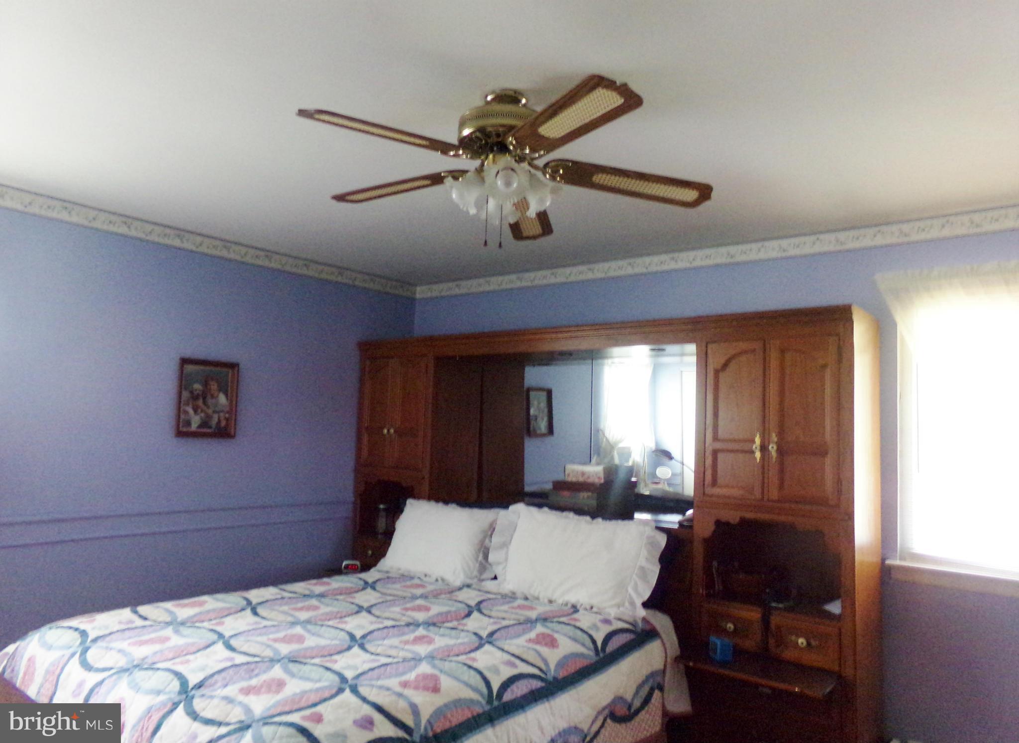 8113 Phirne Road East Glen Burnie, MD 21061 - Photo 24 of 27 a bedroom with a bed and a chandelier