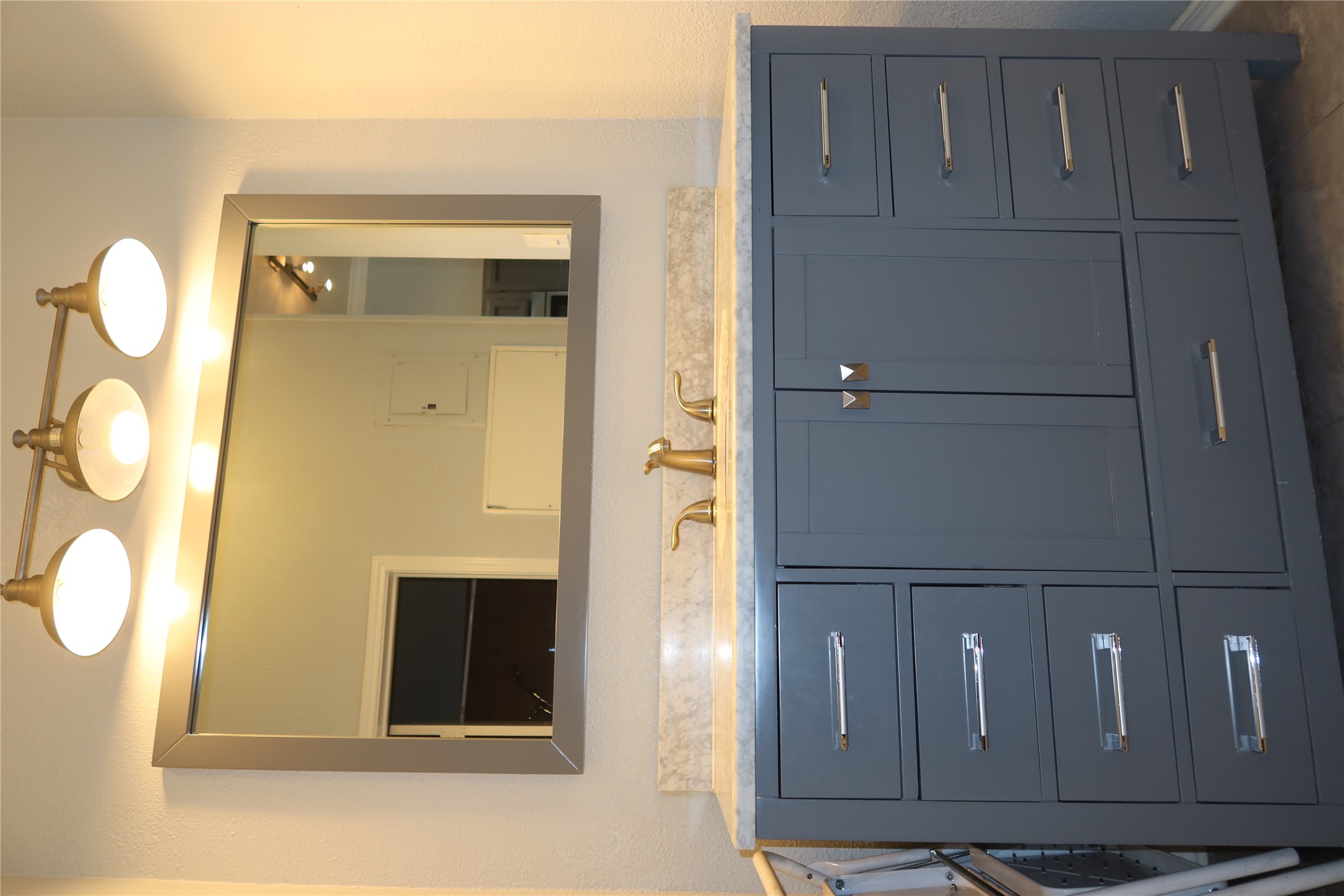 2802 Nueces Street, Unit 306 Austin, TX 78705 - Photo 10 of 20 Bathroom vanity with a white-grey countertop, gold-tone faucet, and a large framed mirror