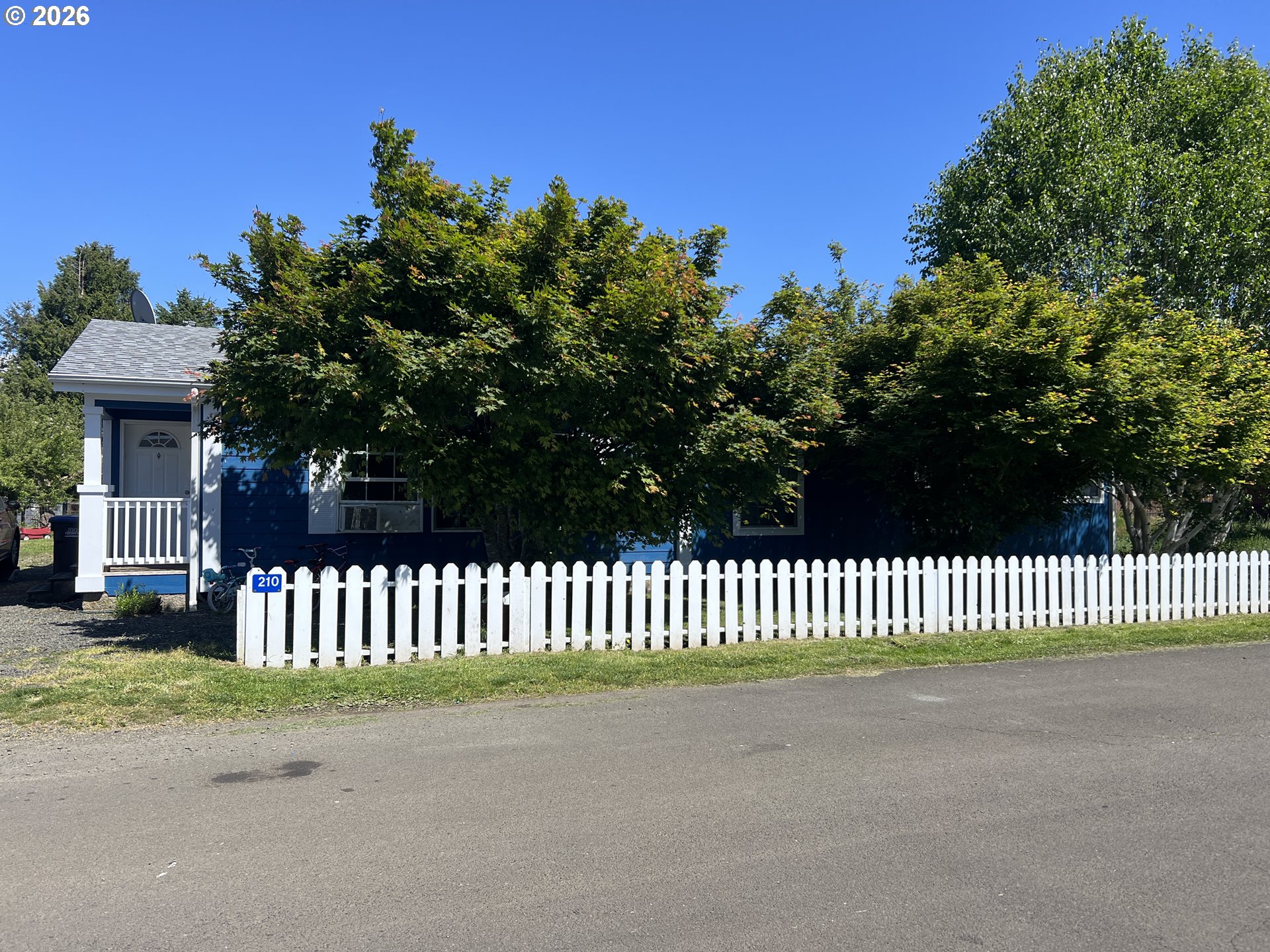 210 Northwest Grinstead Street Siletz, OR 97380 - Photo 2 of 29 a view of a street with a garden