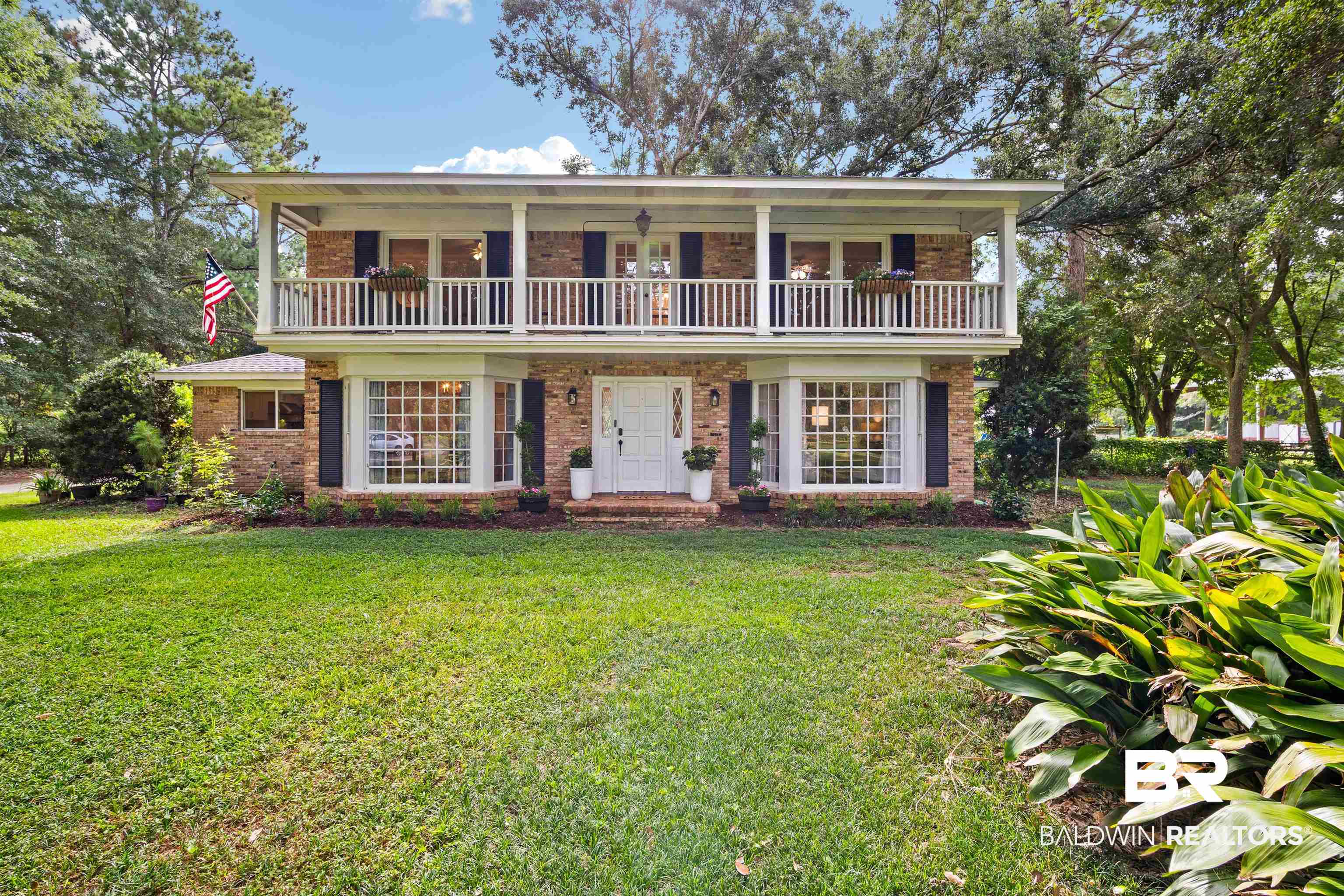700 Eliza Jordan Road North Mobile, AL 36608 - Photo 8 of 44 View of front facade with a balcony, brick siding, and a front yard
