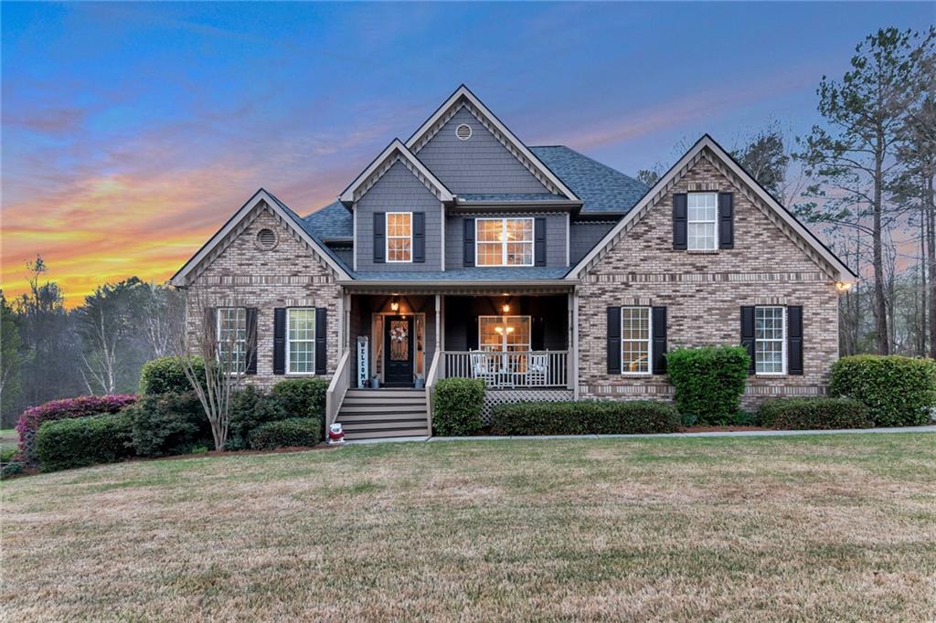 64 Hewett Road Pendergrass, GA 30567 - Photo 1 of 1 a front view of a house with a yard and garage