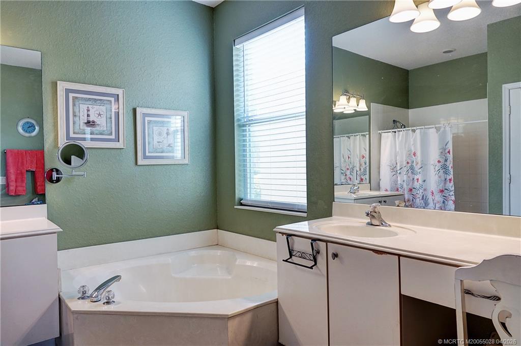 2120 Northwest Marsh Rabbit Lane Jensen Beach, FL 34957 - Photo 21 of 34 a bathroom with a bathtub and a sink