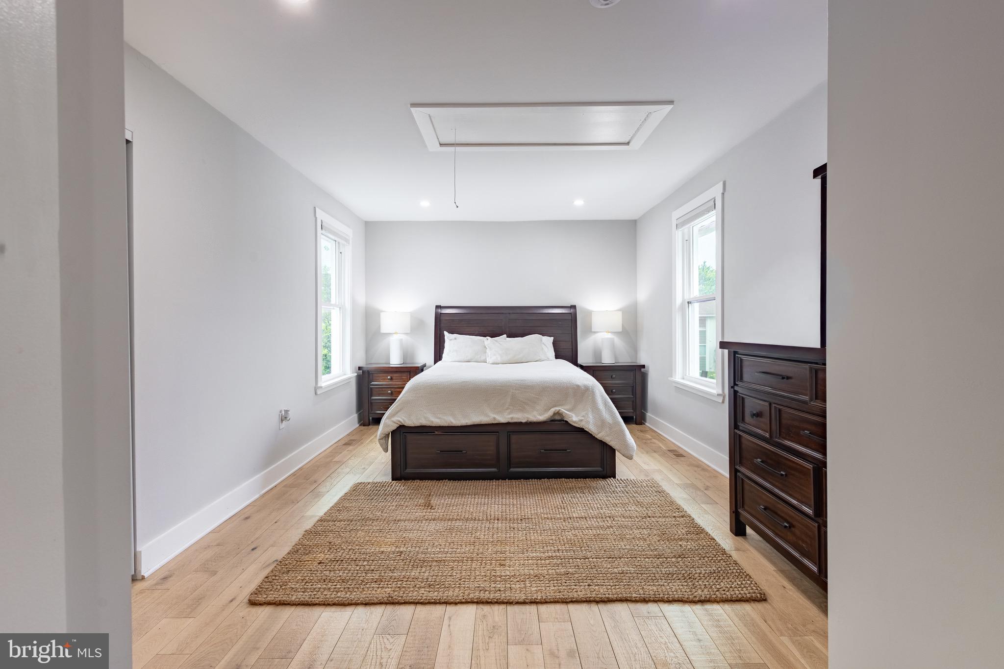 37 4th Street Laurel, MD 20707 - Photo 15 of 26 a spacious bedroom with a bed and wooden floor