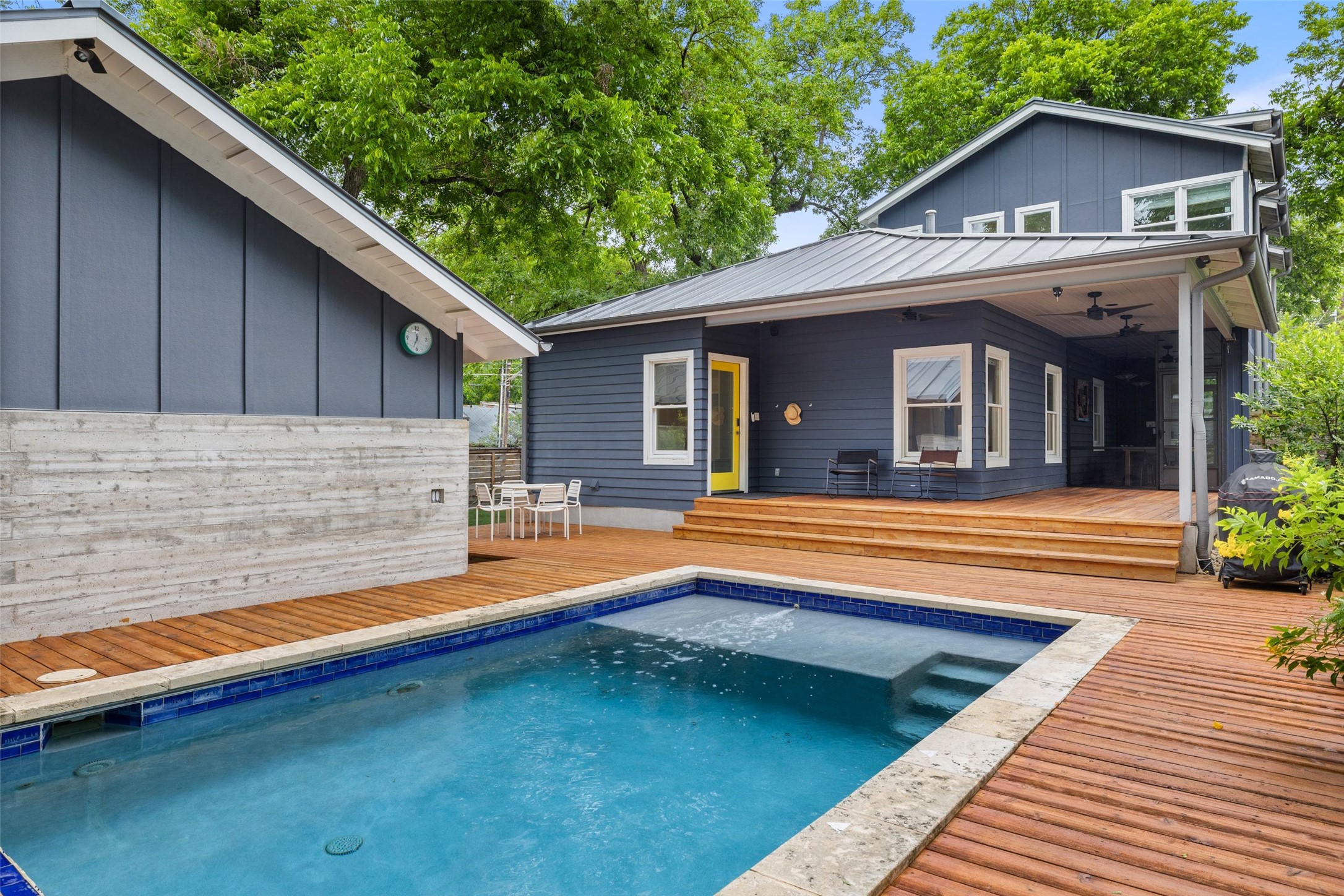 2000 Rundell Place Austin, TX 78704 - Photo 2 of 38 An inviting backyard oasis offers a sparkling pool and generous wooden decking, perfect for outdoor enjoyment.
