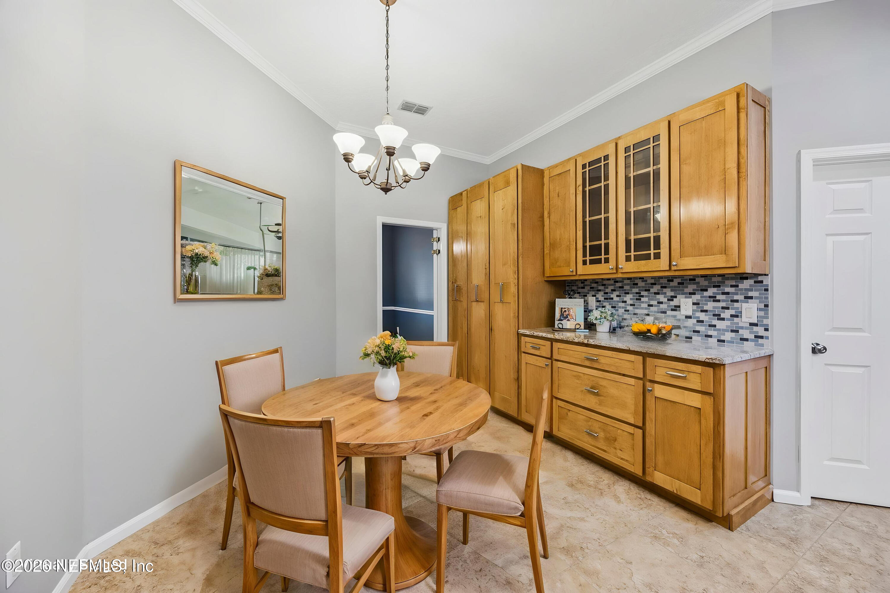 213 Springwood Lane St. Johns, FL 32259 - Photo 22 of 78 a view of a dining room with furniture a chandelier and wooden floor