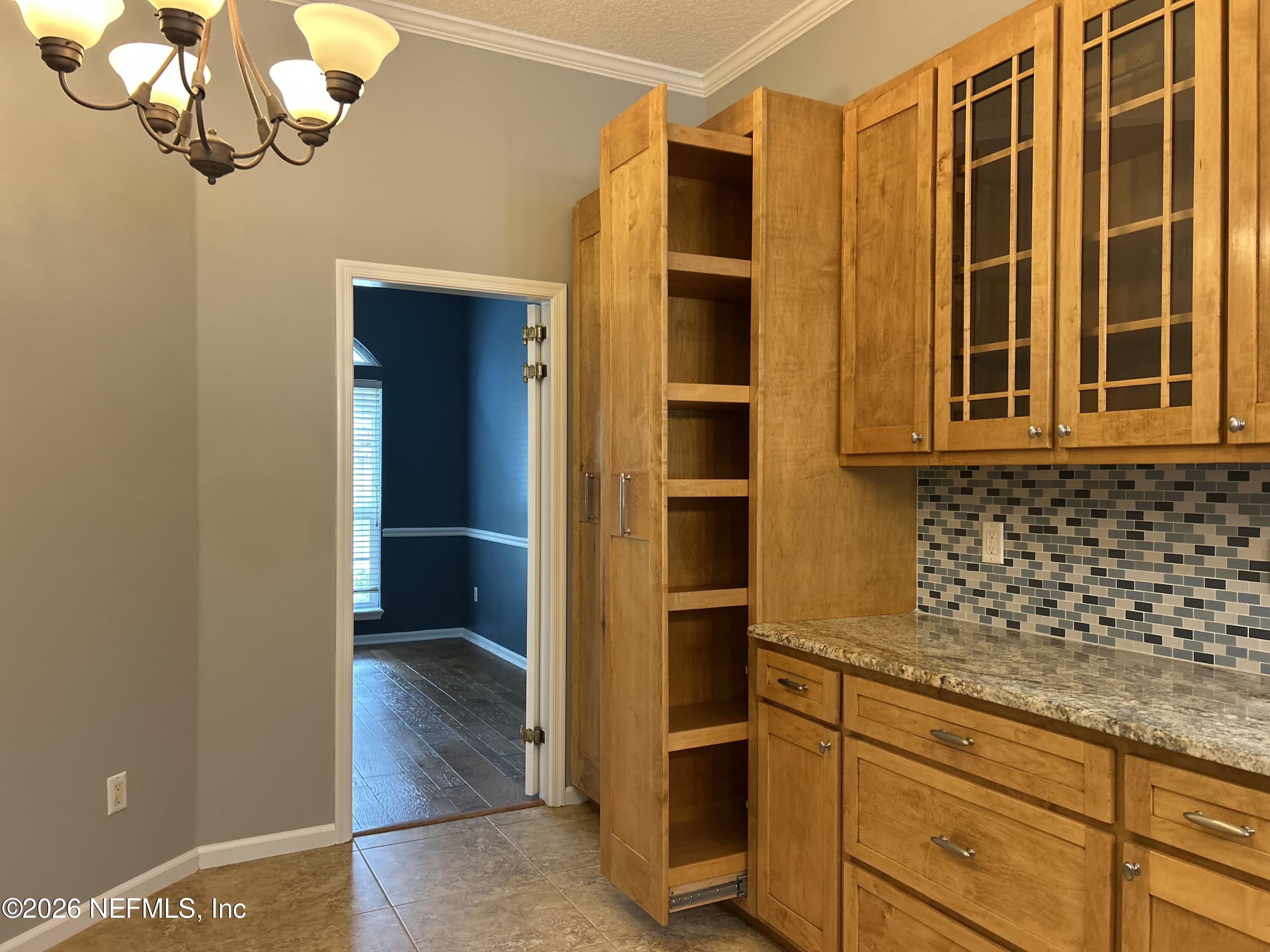 213 Springwood Lane St. Johns, FL 32259 - Photo 23 of 78 a kitchen with a refrigerator and cabinets